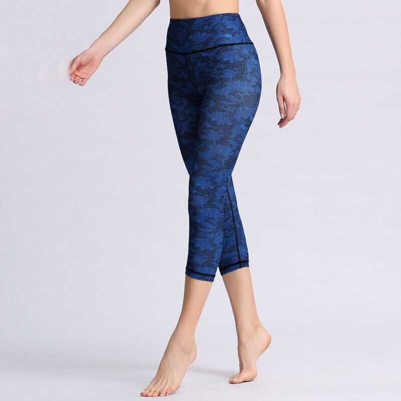 Woman wearing high waist blue floral sports leggings for yoga or fitness.